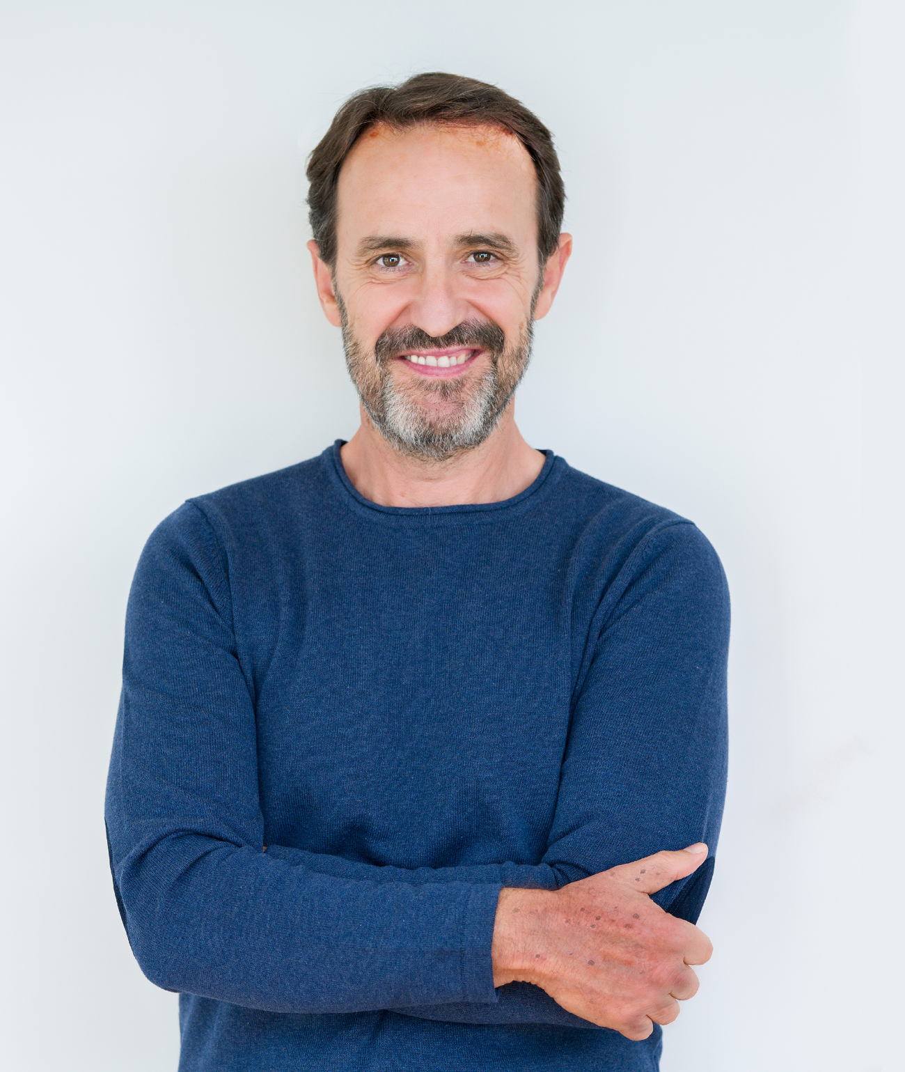 Elegant senior man over isolated background happy face smiling with crossed arms looking at the camera. Positive person.